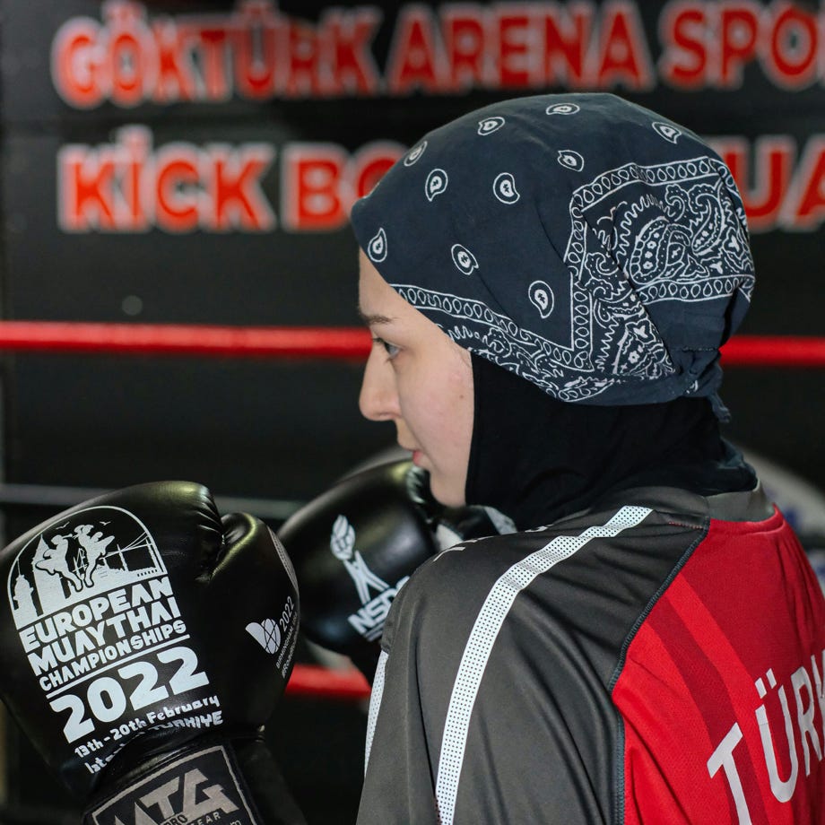 A young boy wearing a black and red bandana