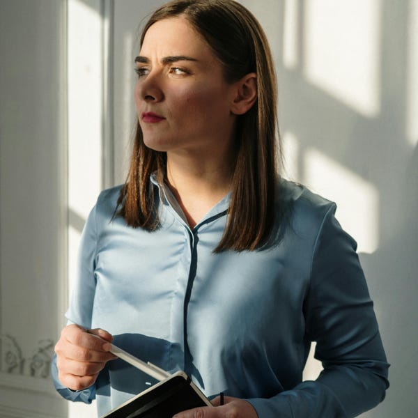 Woman in Blue Dress Shirt Holding Black Tablet Computer